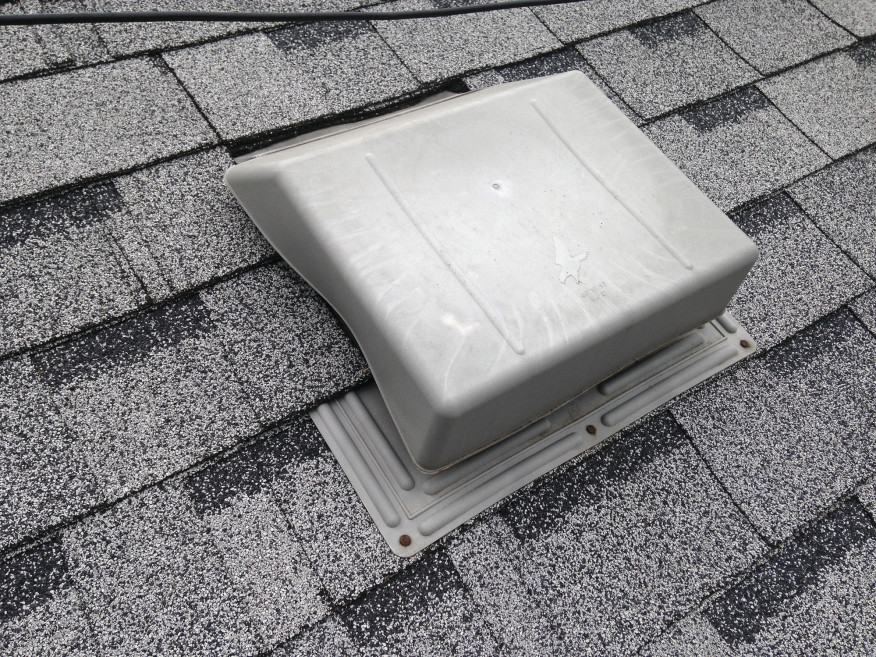 Also shown here is a very poor installation of a self-flashing roof vent. The shingles were not cut carefully around the vent but were instead jammed up against the vent, distorting the hood.